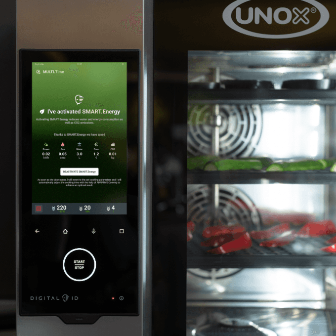 Digital control panel of a Unox professional combi oven displaying automatic energy-saving settings.