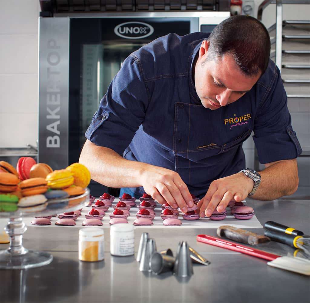 Female chef preparing pastries in front of a Unox CHEFTOP pastry oven